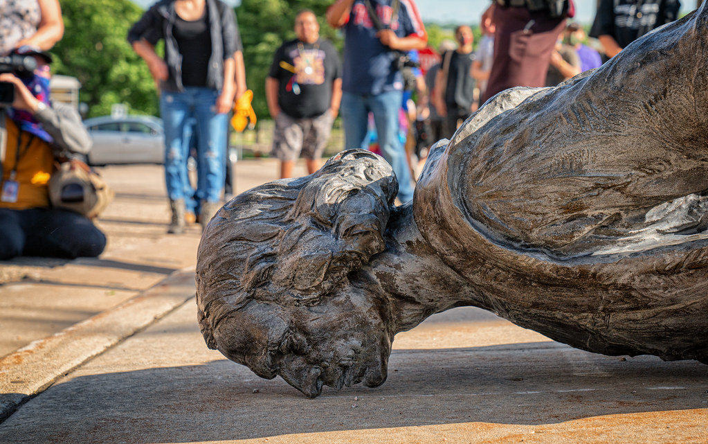 Profile view of a toppled Christopher Columbus statue